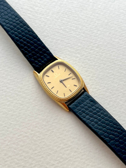 Angled view showing the cushion case and rope bezel of the Omega De Ville watch.