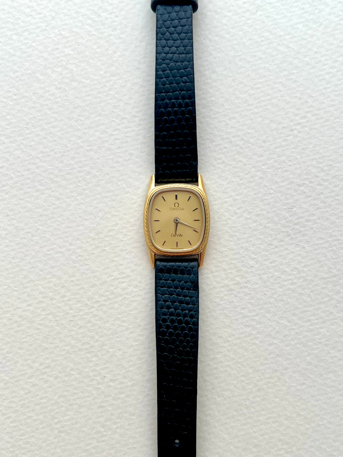 Side profile of the Omega De Ville cushion watch case.