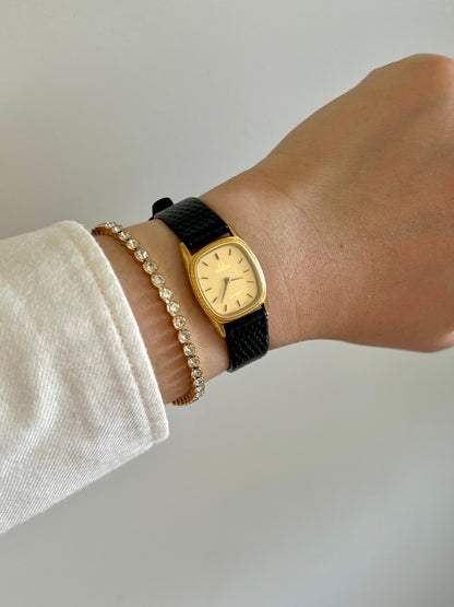 Close view of the gold-tone dial and markers on the Omega De Ville rope-bezel watch.