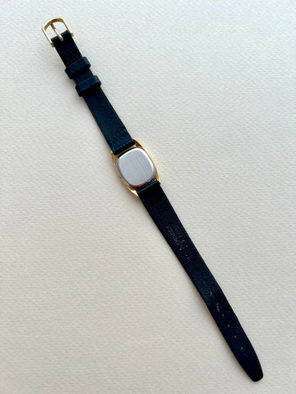 Front view highlighting the dial, cushion case and rope bezel of the Omega De Ville.