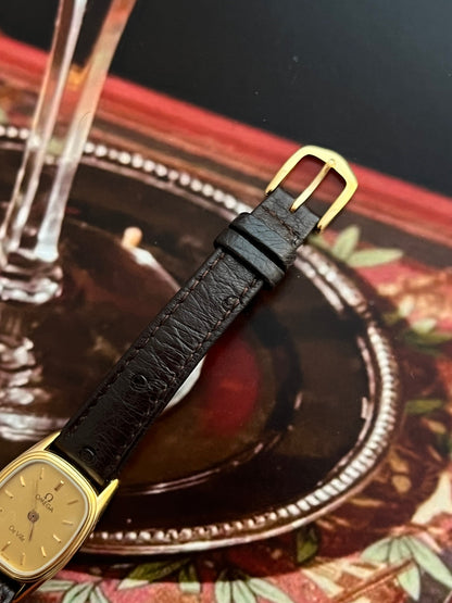 Caseback detail of the vintage Omega De Ville gold-tone cushion watch.