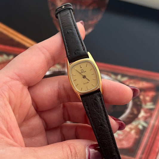 Vintage Omega De Ville small gold-tone cushion watch with champagne dial and genuine ostrich leather strap.