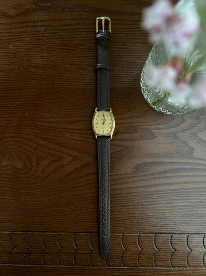 Omega De Ville tonneau grid dial women’s watch, strap detail.