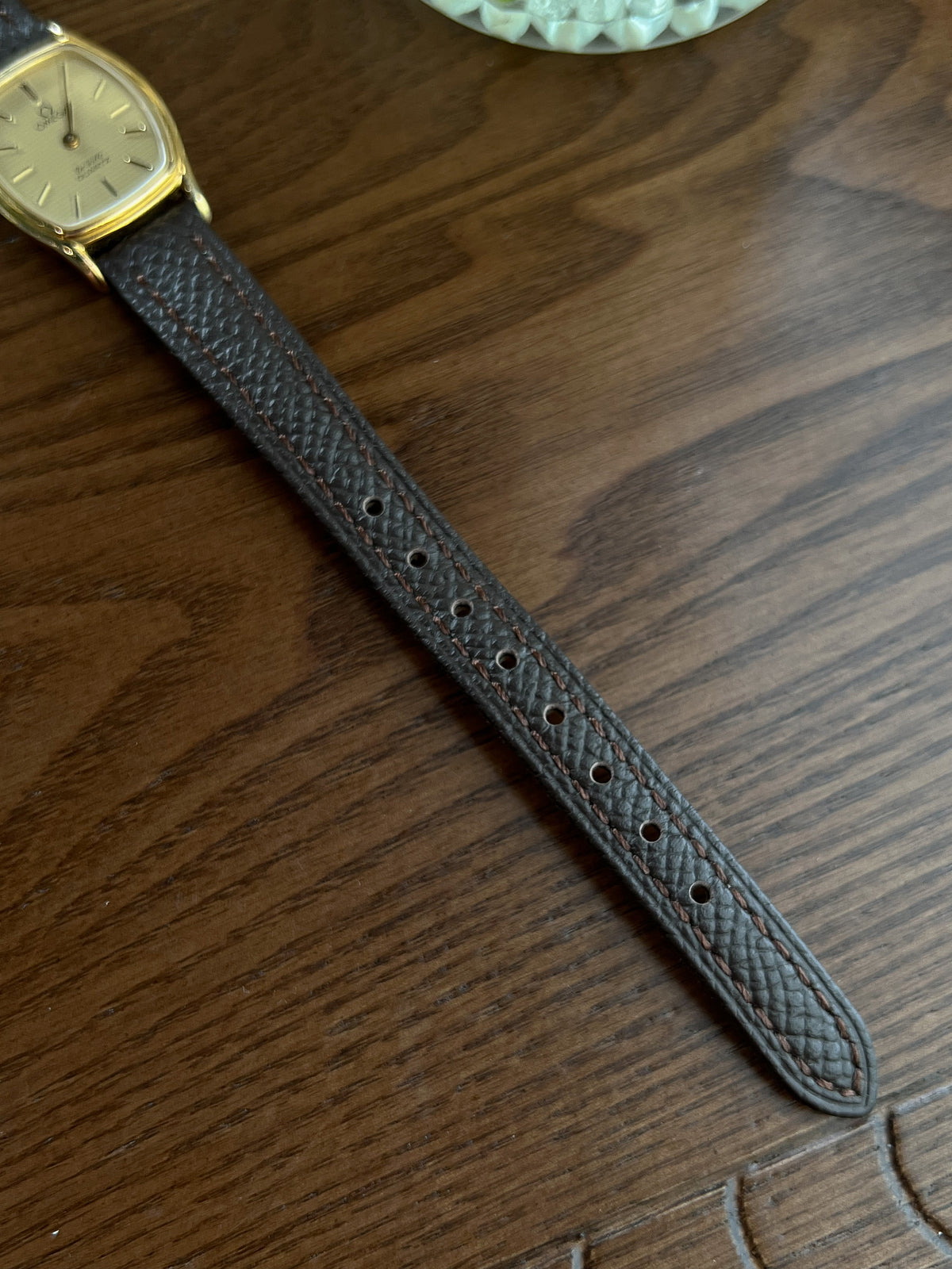 Omega De Ville tonneau grid dial women’s watch, detail view.