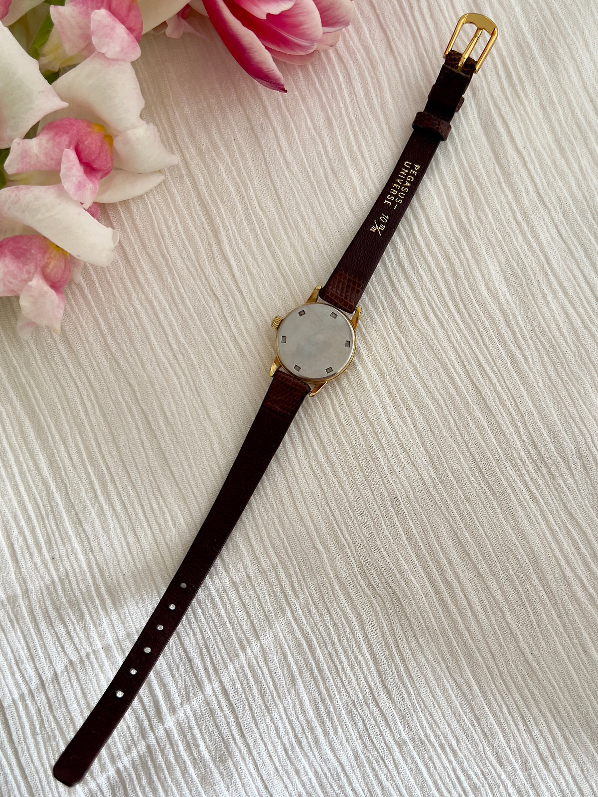 Detail of the champagne sunburst dial on the Omega Geneve watch.