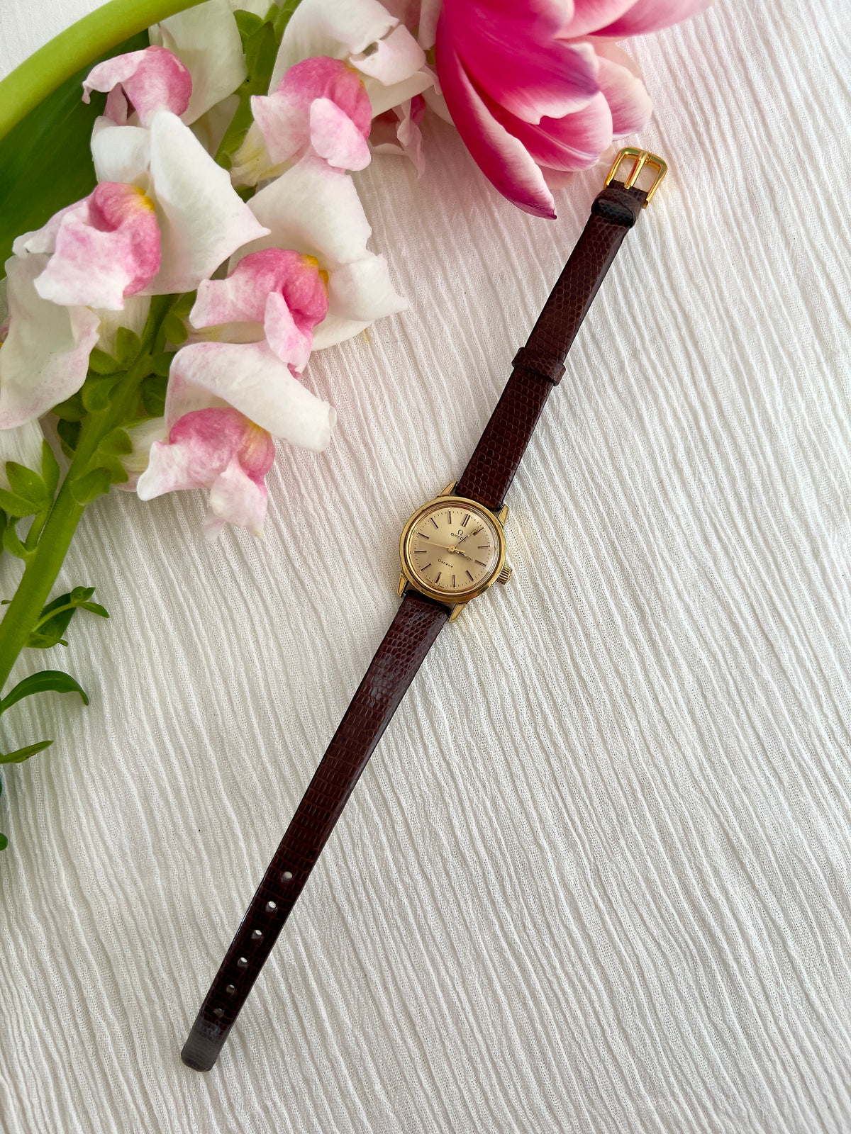 Front view of the Omega Geneve gold-tone automatic watch.