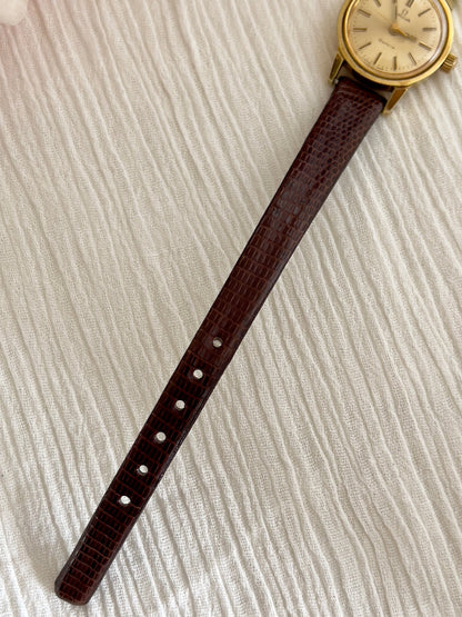 Front view of the Omega Geneve gold watch with champagne sunburst dial.