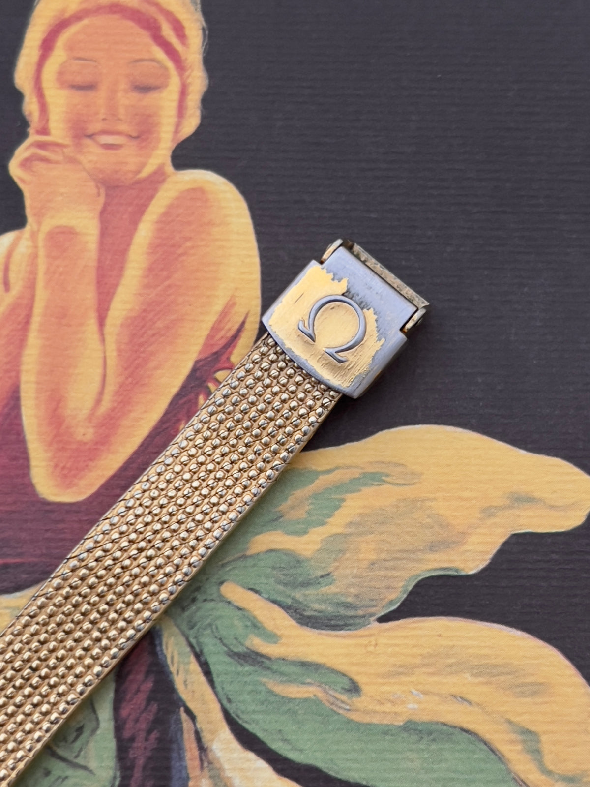 Detail of the Omega Geneve's integrated gold-tone mesh bracelet.