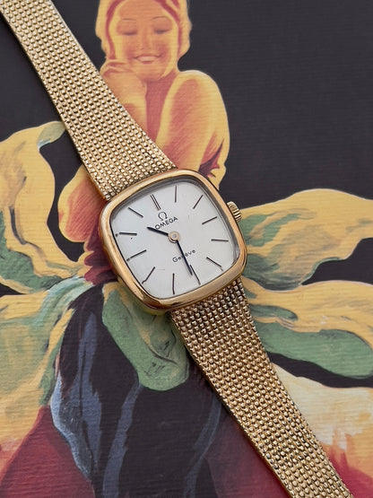 Close-up of the Omega Geneve dial with baton markers and Omega emblem.