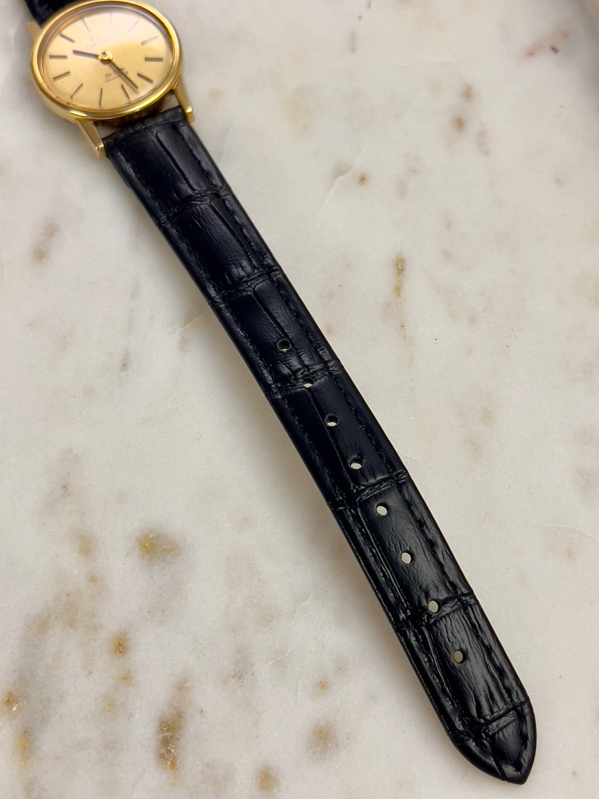 Omega Round Gold Toned Woman's Watch, angled view of a vintage women's watch at Gilded Hour.