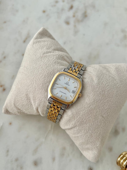 Angled view of Omega Seamaster Brest 396.1011 two tone women’s watch with white textured dial and original bracelet