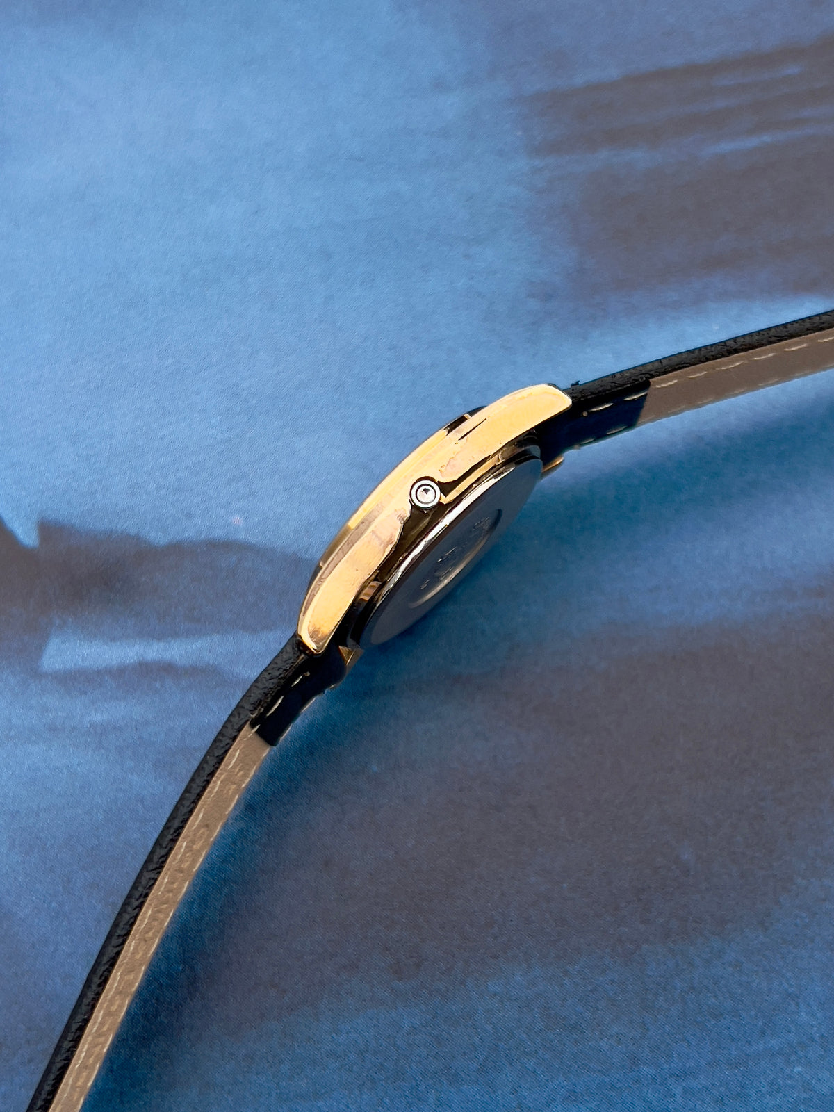 Angled view of the Omega Seamaster gold-tone watch.