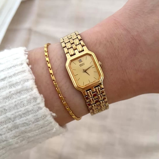 Vintage Seiko gold tank watch with rectangular case and cream dial