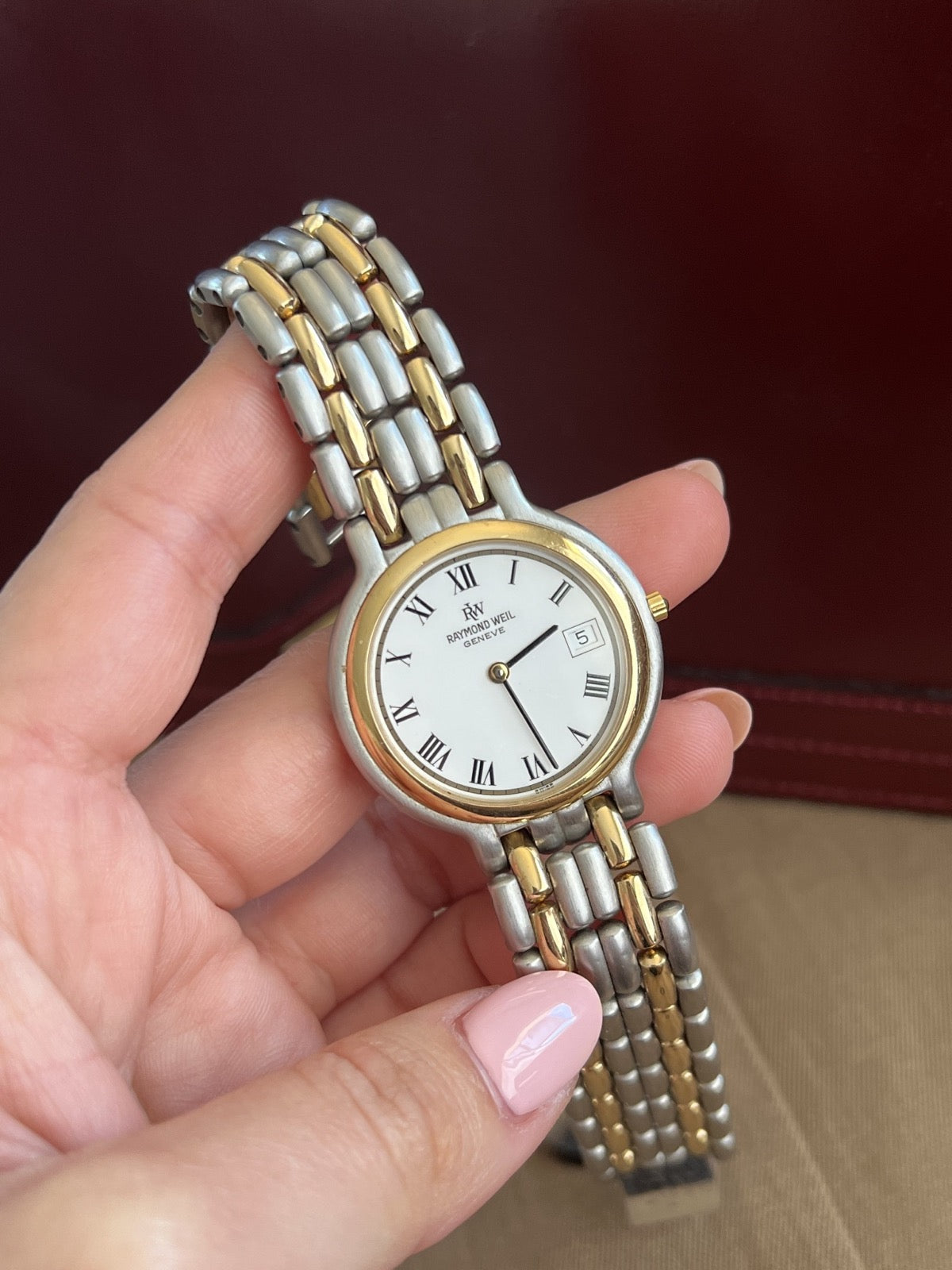 Raymond Weil Fidelio white Roman numeral dial held in the hand