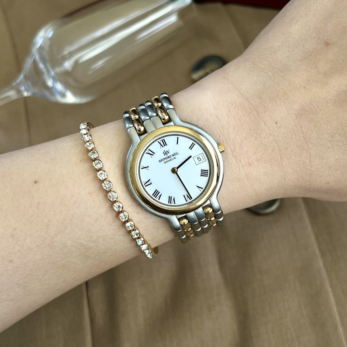 Raymond Weil Fidelio two tone watch with white Roman numeral dial worn on a 15 cm wrist