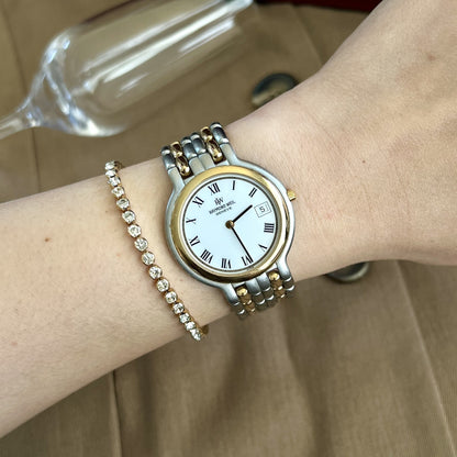Raymond Weil Fidelio two tone watch with white Roman numeral dial worn on a 15 cm wrist
