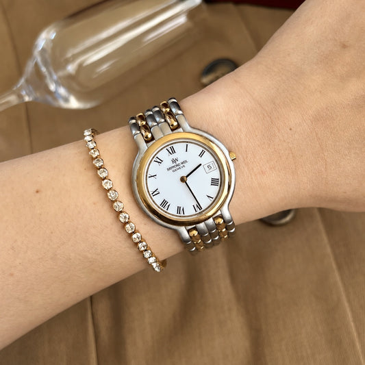 Raymond Weil Fidelio two tone watch with white Roman numeral dial worn on a 15 cm wrist