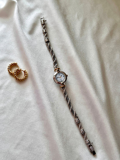 Seiko Exceline women’s watch with a white Roman numeral dial, two-tone case, and original rope bracelet.