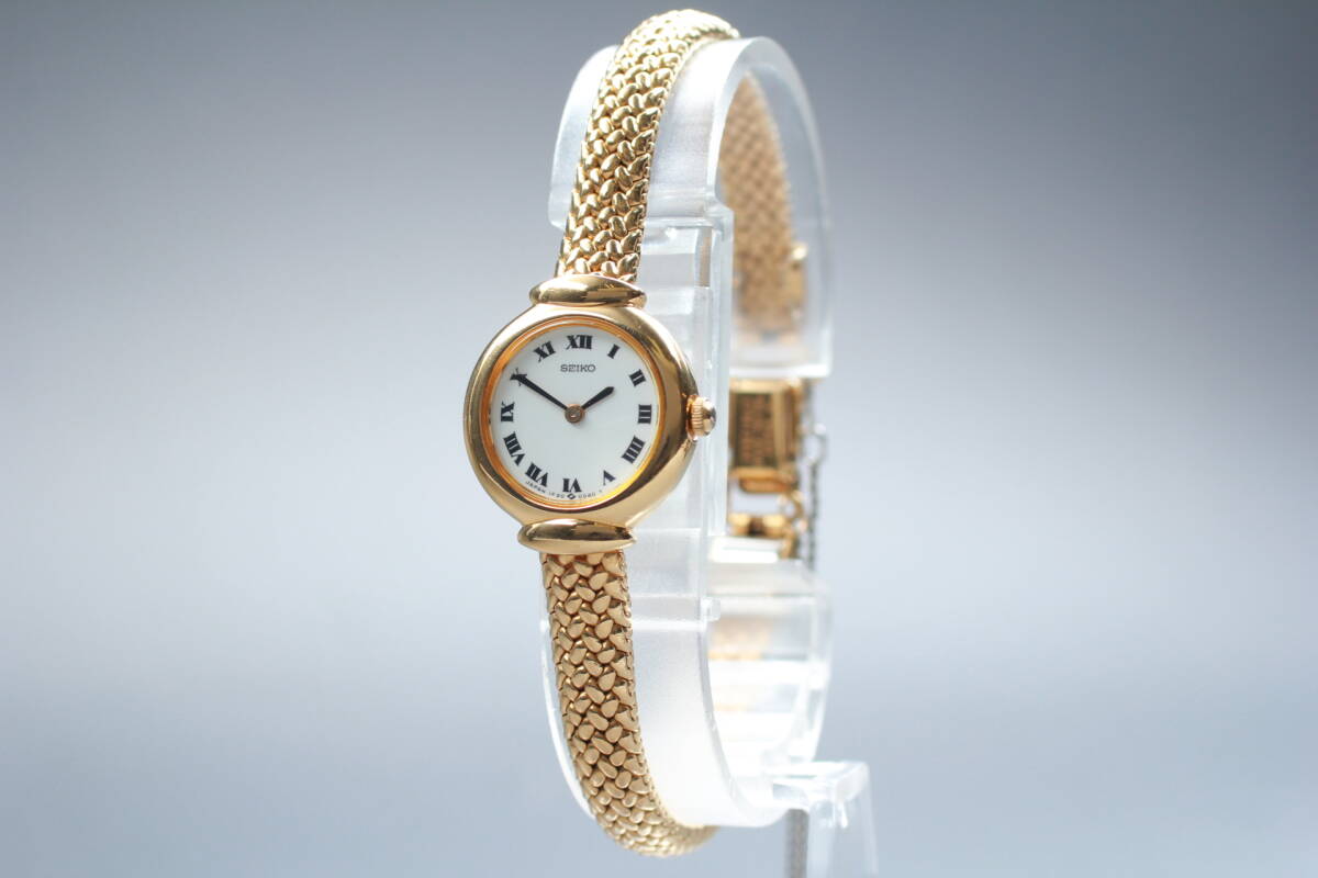 Seiko 1F20-0A40 gold-tone bracelet watch with white Roman numeral dial