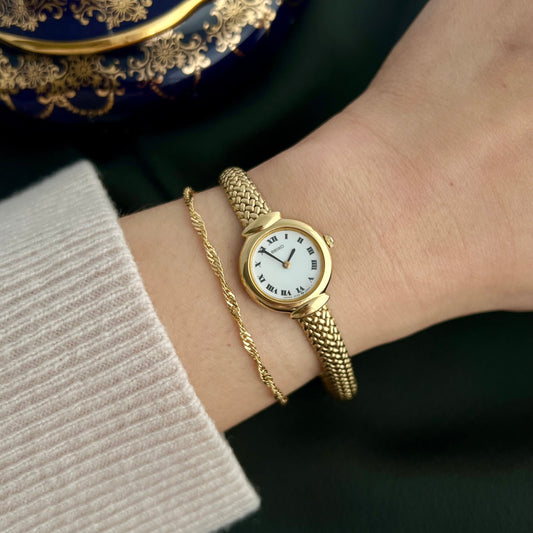 Seiko 1F20-0A40 gold-tone Roman dial bracelet watch worn on the wrist