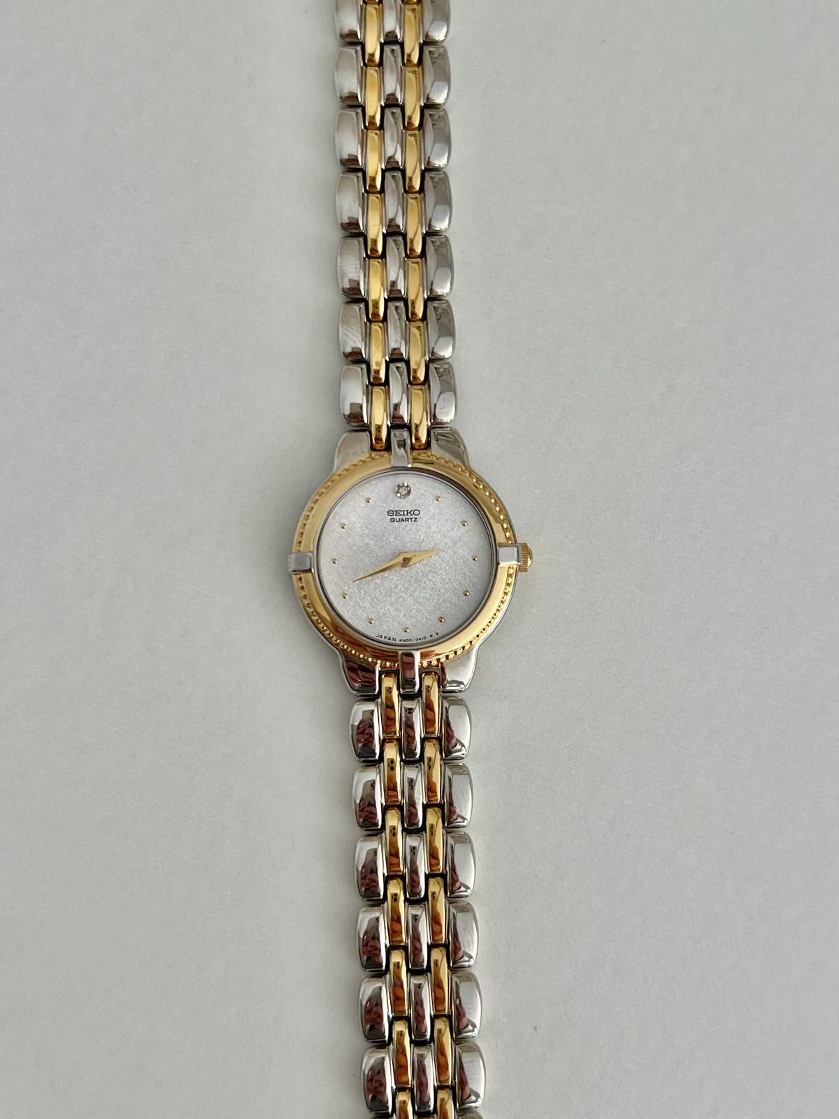 Seiko 4N00-0910 diamond-accent two-tone watch shown on the wrist.