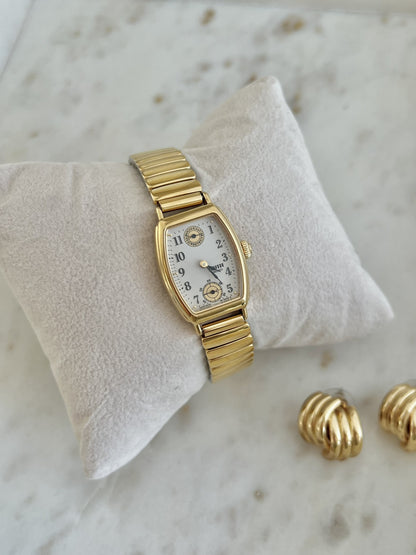 Angled view of Seiko Avenue 8E38-5000 gold-tone tonneau watch and expandable bracelet