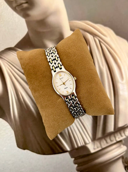 Angled view of the Seiko Belfina oval case and woven two-tone bracelet.