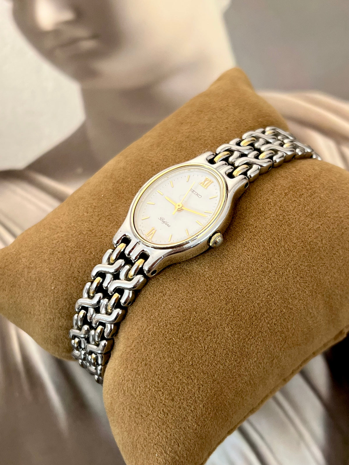 Detail of the Seiko Belfina woven silver bracelet links with gold accents.