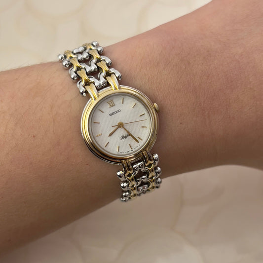 Seiko Belfina Two Tone Ladies Watch with Intricate Bracelet — watch face and case shown from the front.