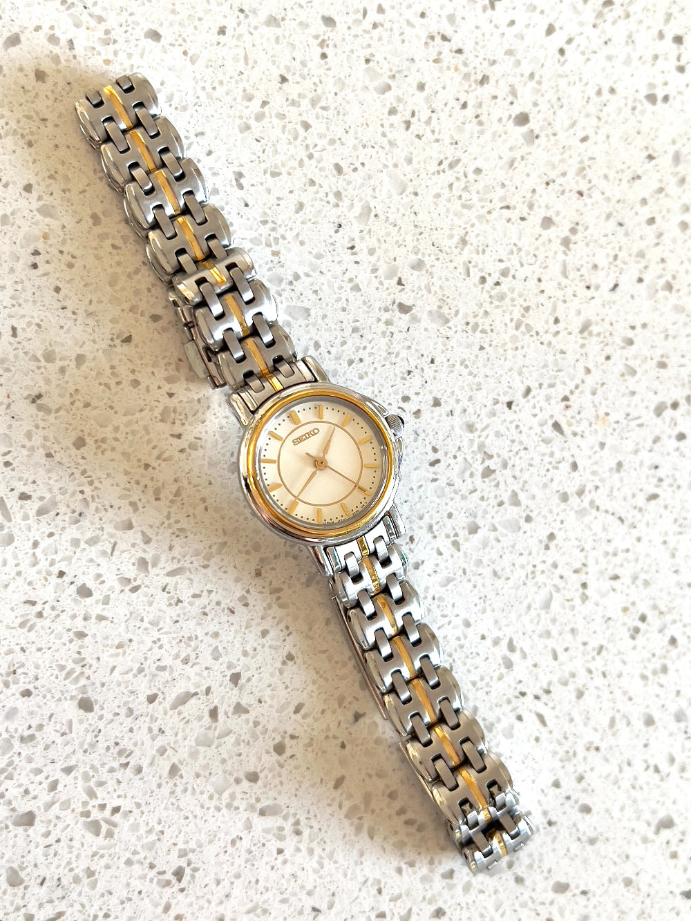 Seiko Two Tone Woman's Watch with Black Crown Stone — closer view of the dial and bezel.