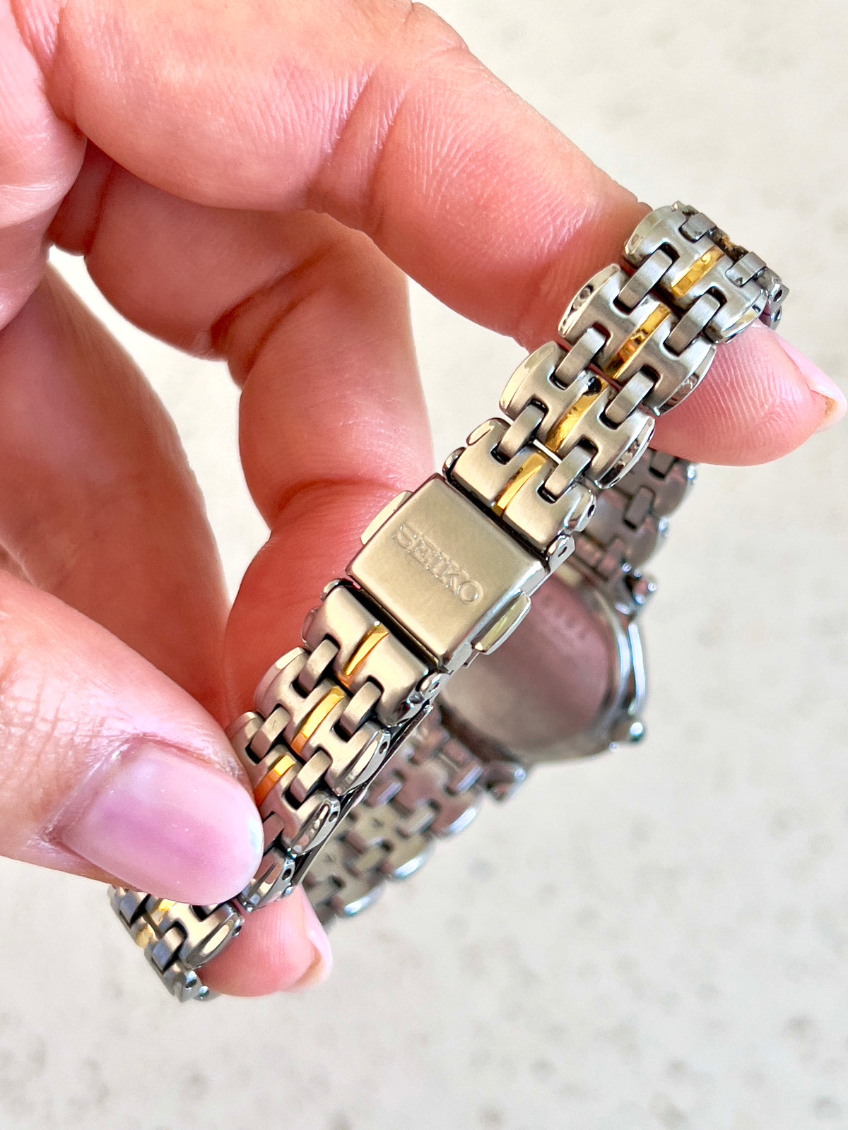 Seiko Two Tone Woman's Watch with Black Crown Stone, angled view of a vintage women's watch at Gilded Hour.