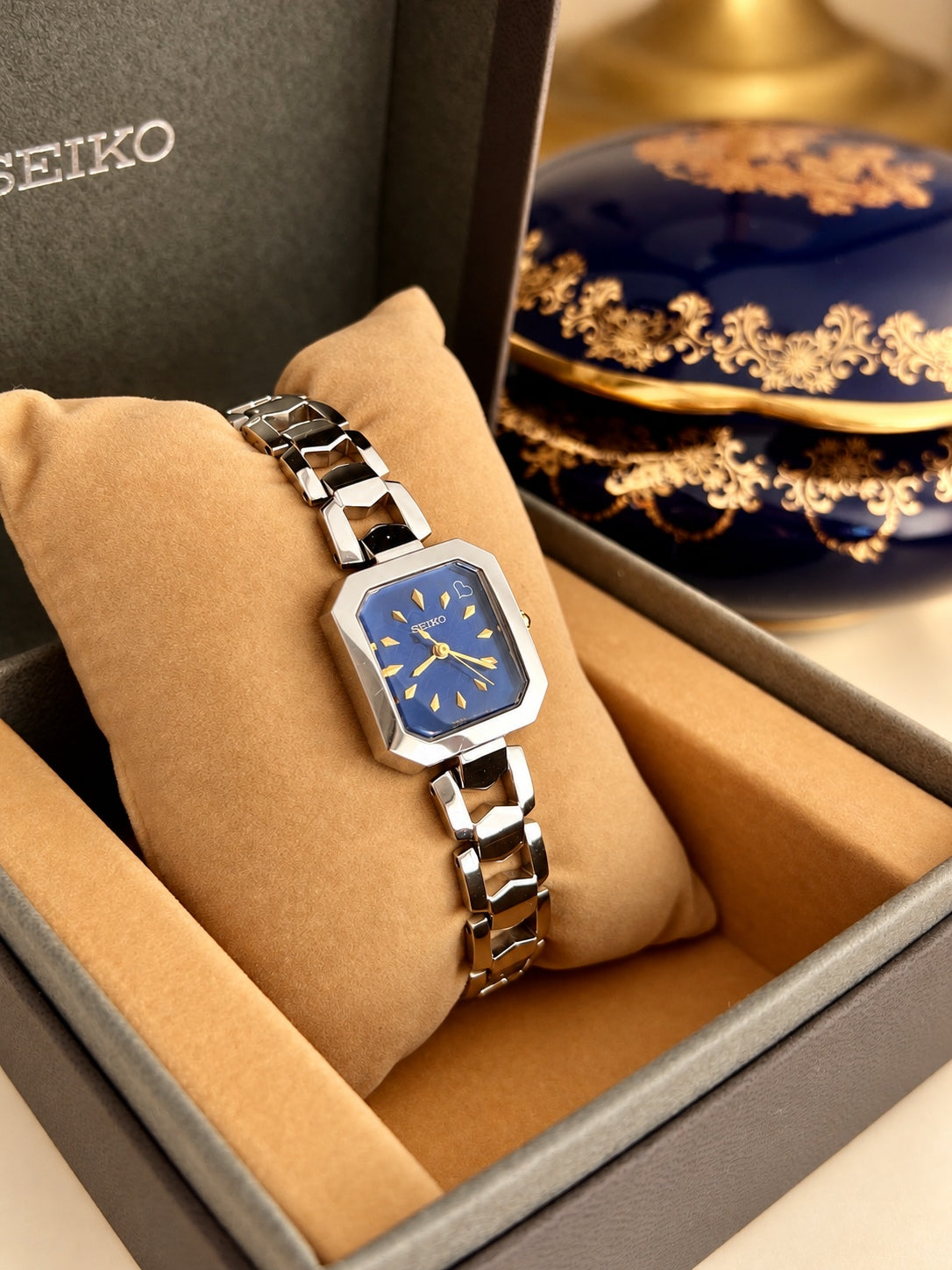 Angled view of the Seiko blue dial women’s watch and sculpted silver bracelet in its original Seiko box