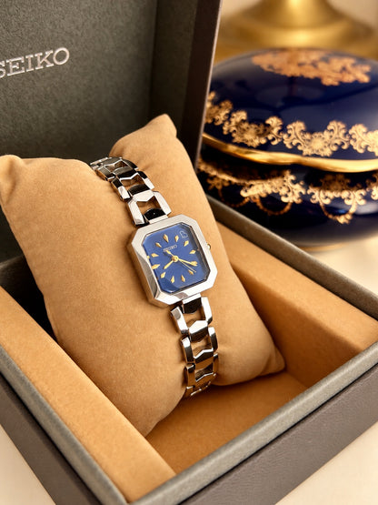 Angled view of the Seiko blue dial women’s watch and sculpted silver bracelet in its original Seiko box