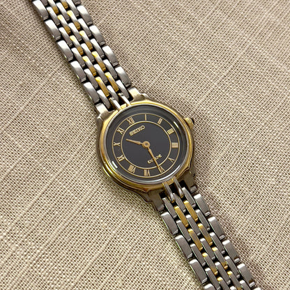 Seiko Exceline Two-Tone Woman’s Watch – Deep Blue & Gold Roman Dial — the navy Roman numeral dial and two-tone bracelet shown from the front.