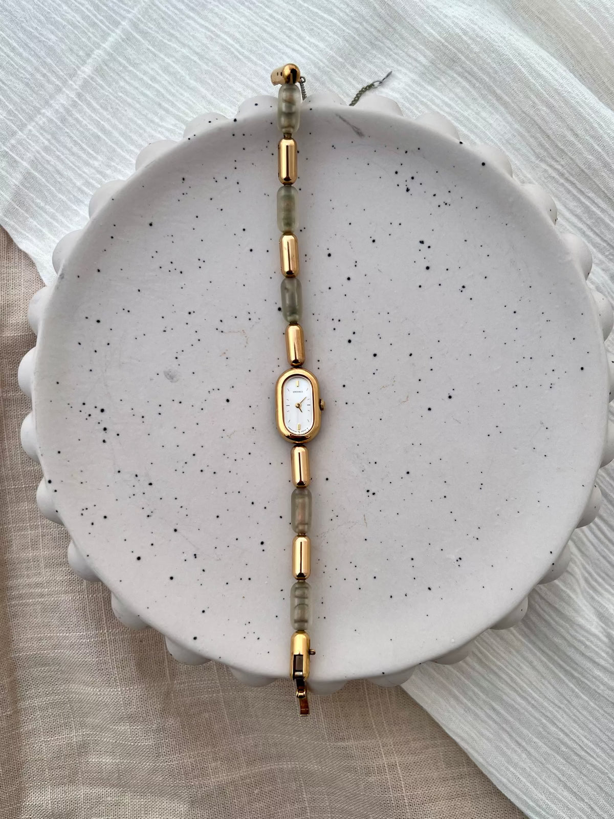 Detail of the Seiko bracelet's gold links and translucent resin segments.