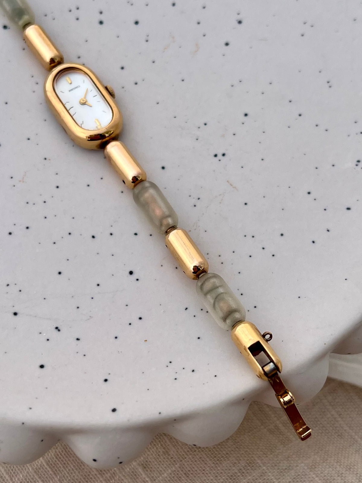 Caseback detail of the Seiko gold-tone capsule watch.