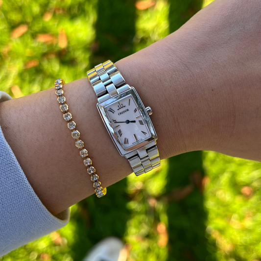 Seiko Credor ladies watch with rectangular silver case, Roman numeral dial, stainless steel bracelet, Japanese luxury dress watch styling and feminine jewellery pairing