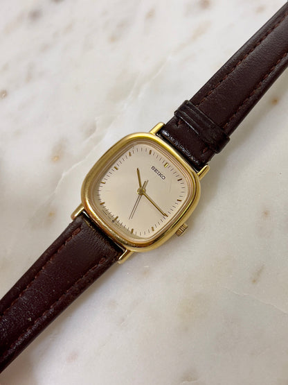 Seiko Gold Toned Cushion Case Woman's Watch, angled view of a vintage women's watch at Gilded Hour.