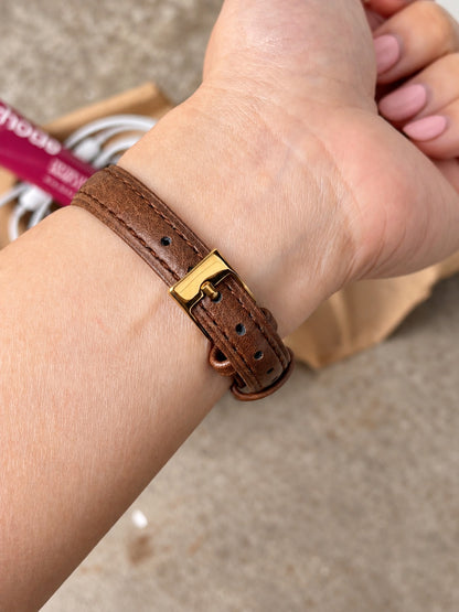 Brown leather strap with matching stitching and gold tone pin buckle on the Seiko Exceline watch.