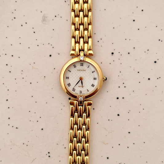 Close-up of the Seiko Exceline guilloche dial with black Roman numerals and gold-tone hands.