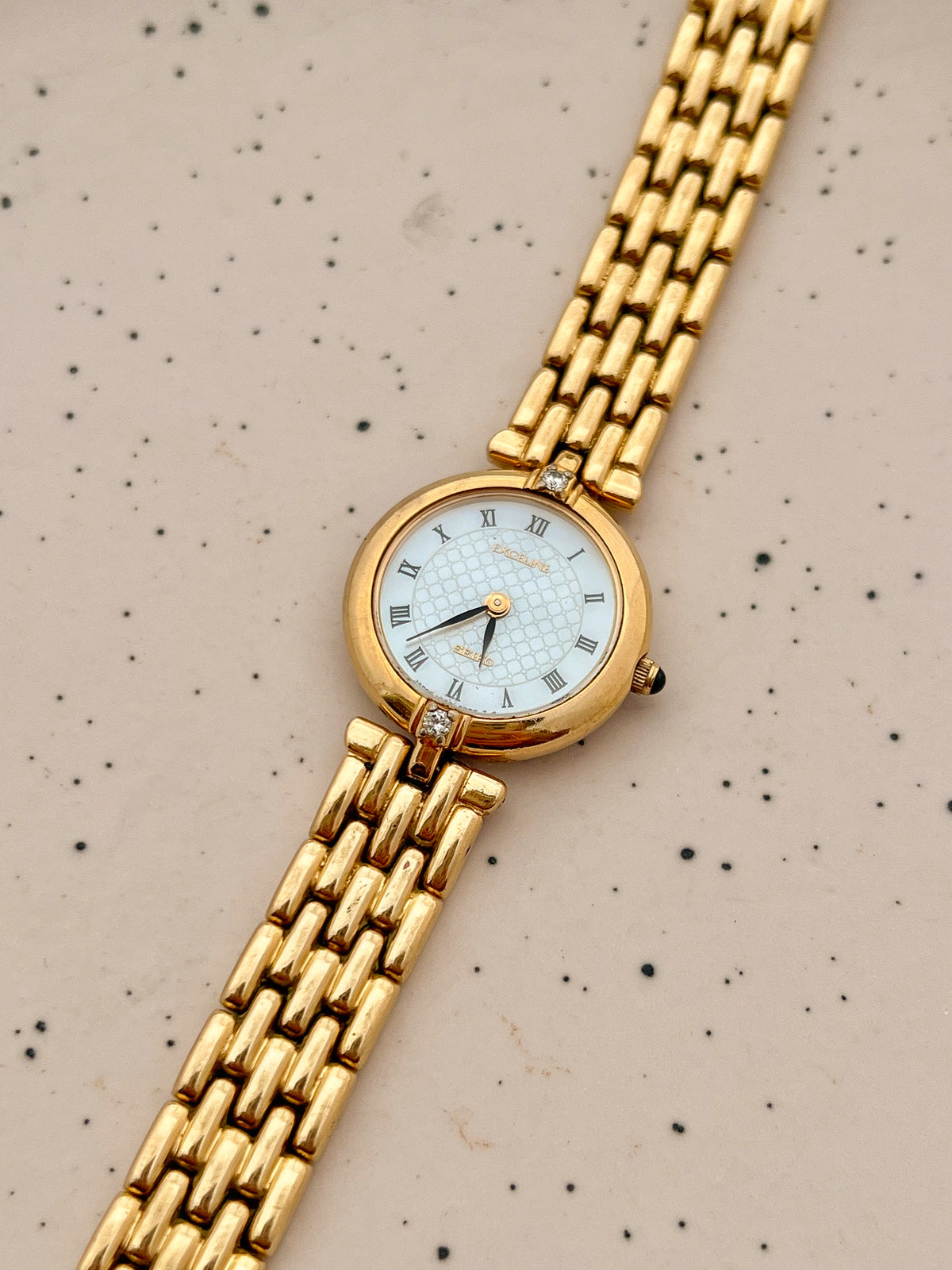 Seiko Exceline Roman Dial Gold Diamond Accent Women’s Watch, dial and diamond detail.
