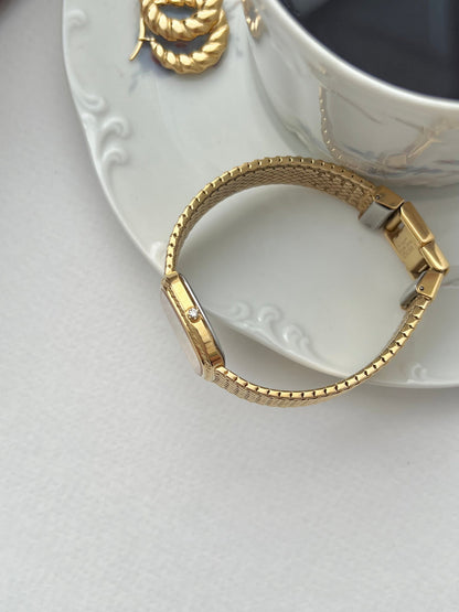 Additional front view of the Seiko Exceline gold dial and diamond-set crown.
