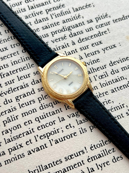 Side profile of the Seiko Exceline gold-tone case and domed sapphire crystal.