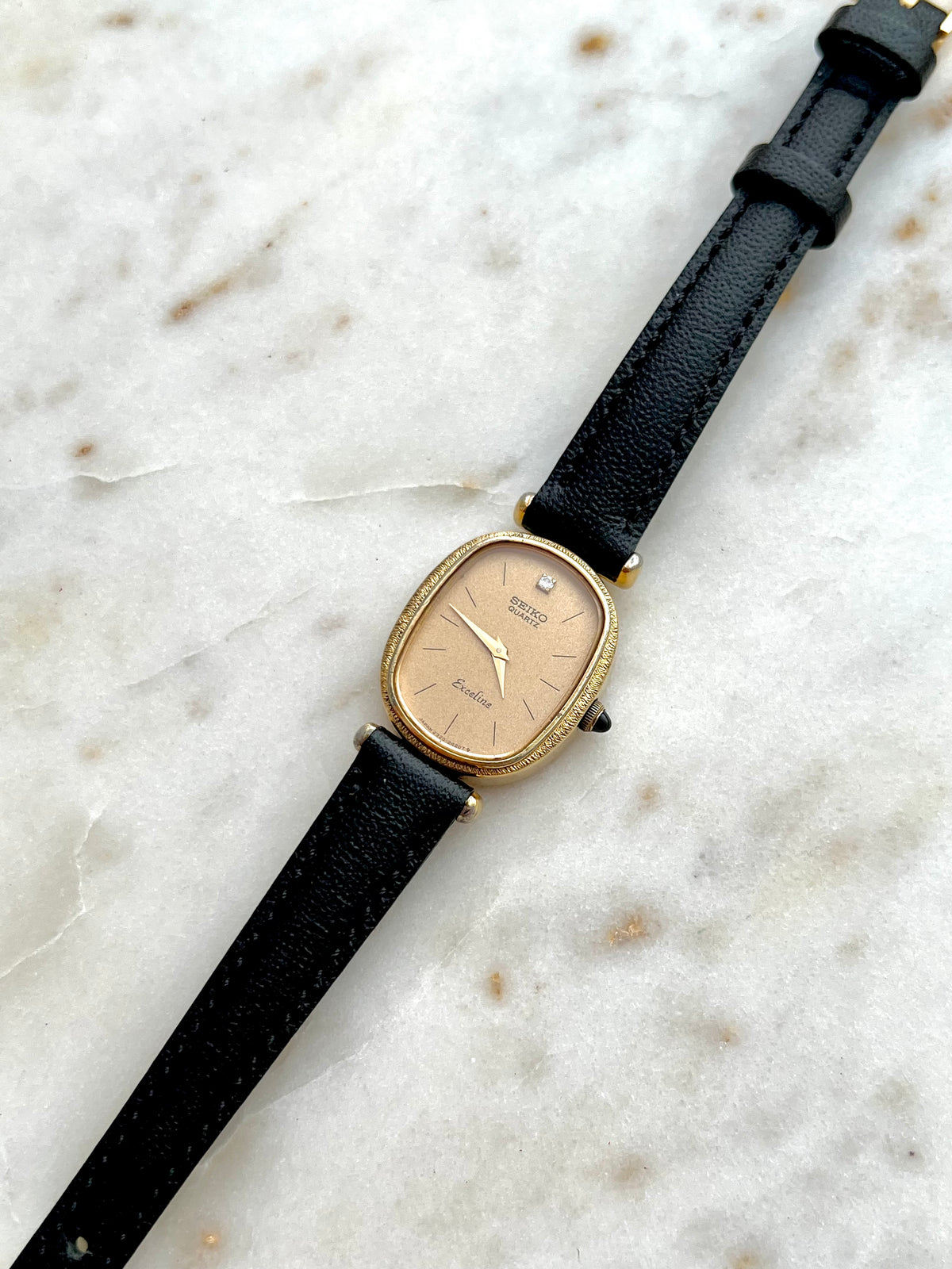 Seiko Exceline One Diamond Gold Dial Leather watch 2320-6200: angled view of the dial and case.