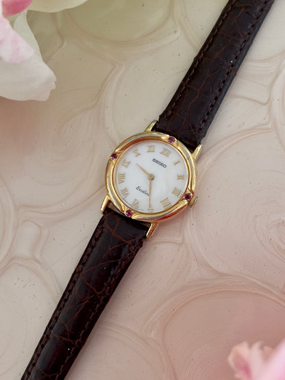 Seiko Exceline Mother of Pearl Women’s Watch with Ruby Accents — close view of mother of pearl dial.