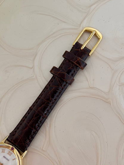 Seiko Exceline Mother of Pearl Women’s Watch with Ruby Accents — strap buckle and leather texture.