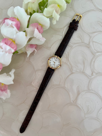 Seiko Exceline Mother of Pearl Women’s Watch with Ruby Accents — dial and textured leather strap.