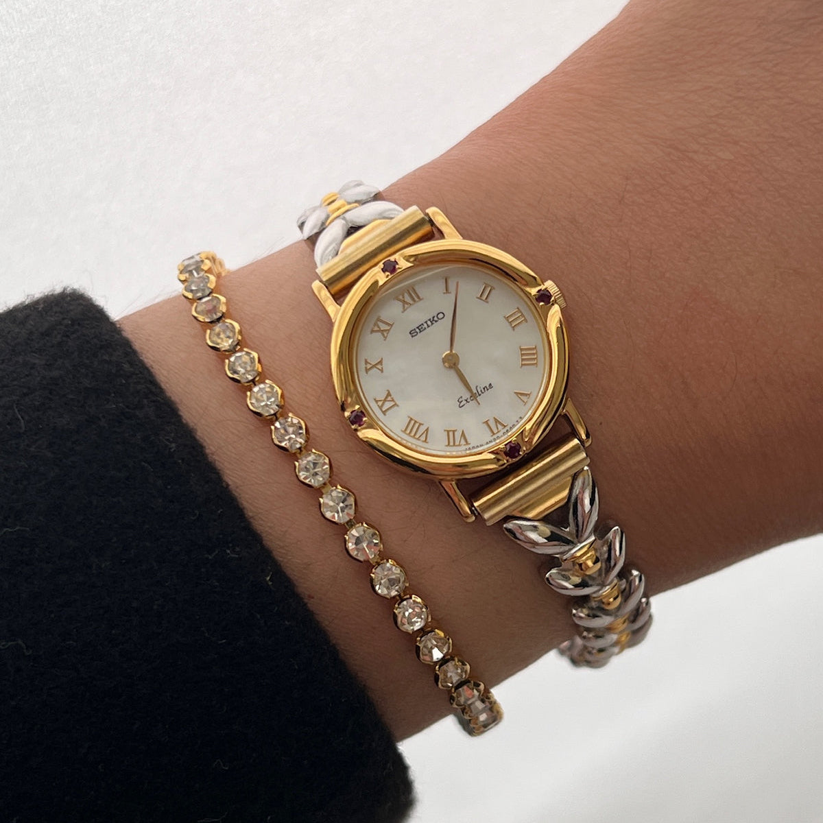 Seiko Exceline Ruby Accent Two Tone Women’s Watch featuring mother of pearl dial and two tone bracelet; vintage watch product image 1.