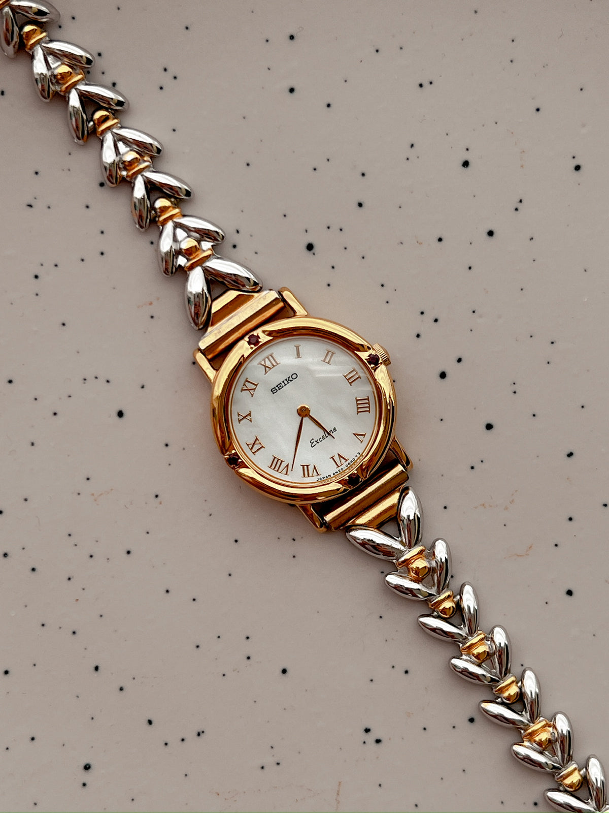 Seiko Exceline Ruby Accent Two Tone Women’s Watch featuring mother of pearl dial and two tone bracelet; vintage watch product image 2.