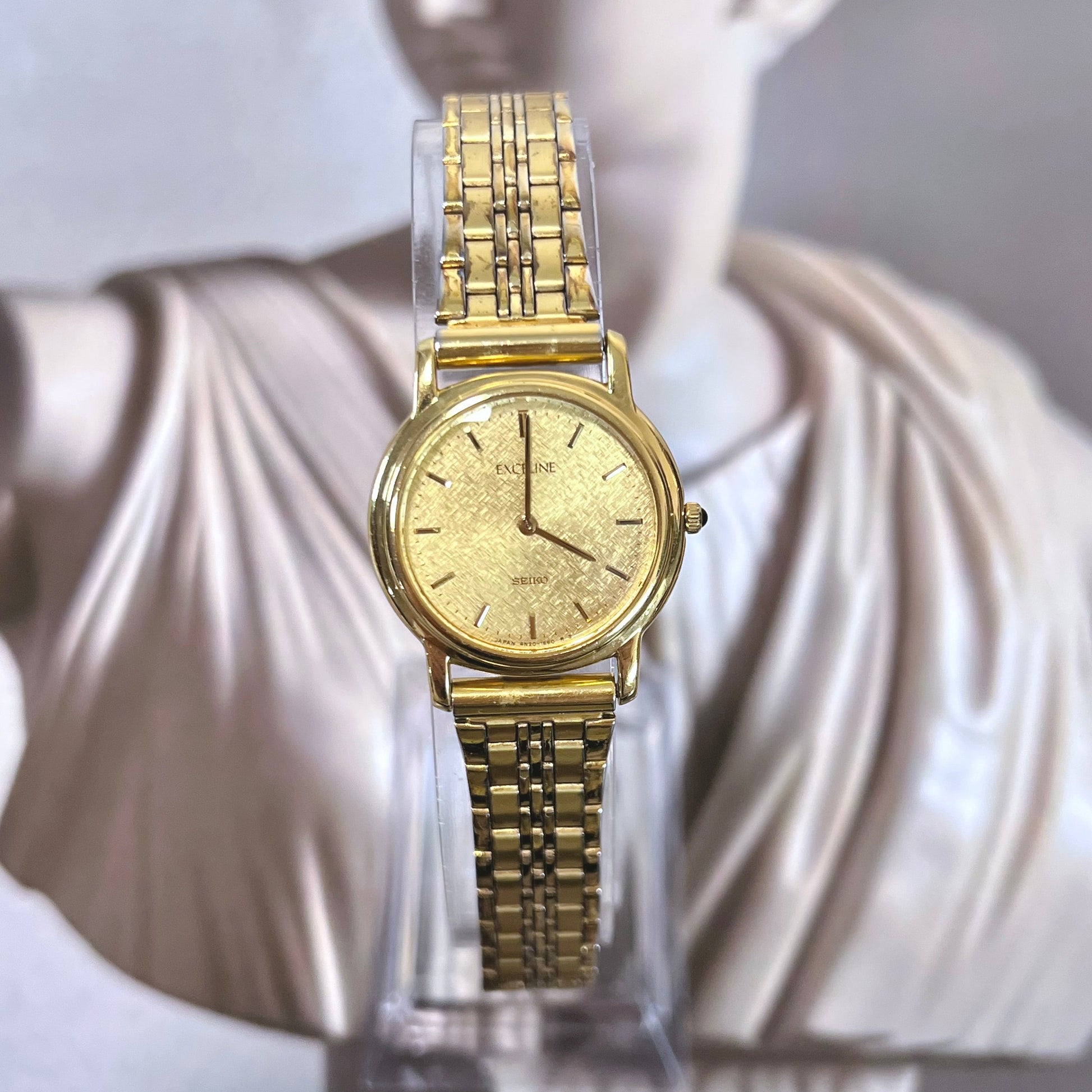 Seiko Exceline ladies watch with snowflake textured gold dial, gold tone jewellery bracelet, elegant Japanese dress watch and vintage Seiko design